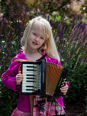 Five year old Ivy loves playing accordion.