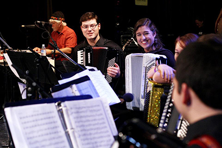 A group of musicians playing accordion and staying motivated together. 