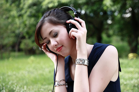 Woman listening through headphones.